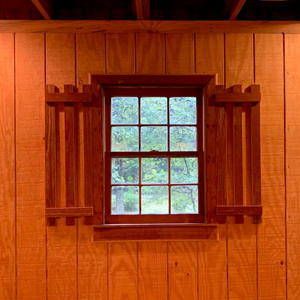 Framed Window with Square panes against Cedar Panel Walls.