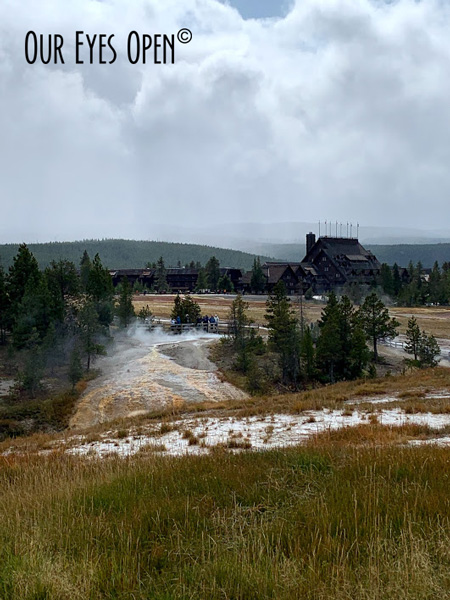 Geyser basin on the grounds of Old Faithful looking towards the Old Faithful Inn at Yellowstone National Park.
