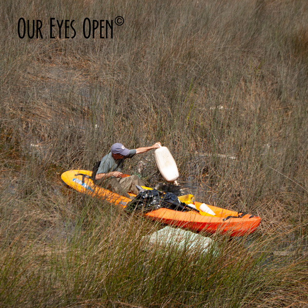 Frank picking garbage out of the salt marsh on the St. Johns River.