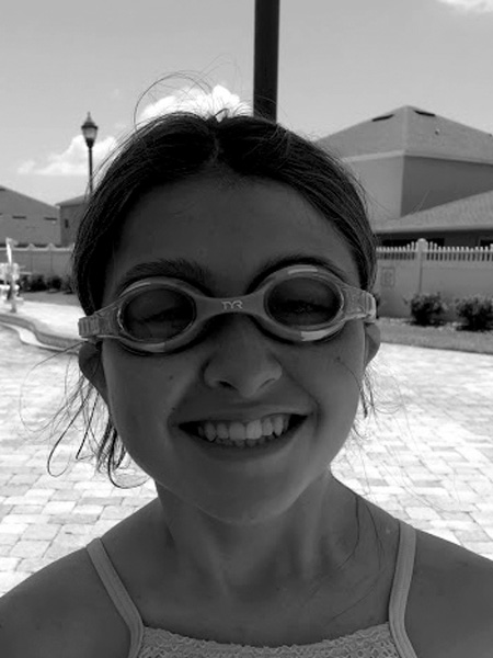 Oldest granddaughter getting ready to go for a swim in the pool at her 14th birthday party one year ago.