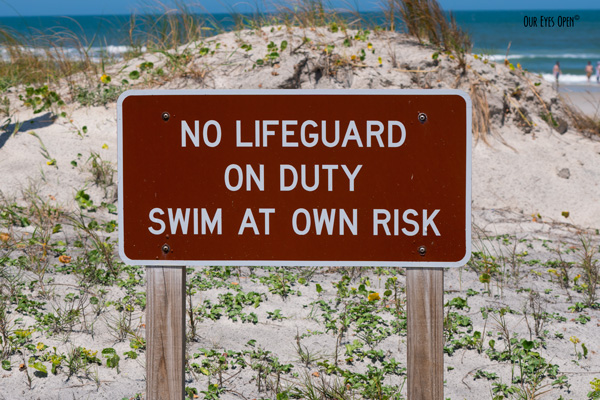 No Lifeguard on Duty, Swim at Own Risk Sign on the boardwalk.
