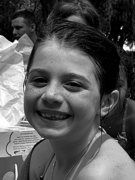 My middle granddaughter with a big smile on her face that is covered in freckles at her birthday party last summer.