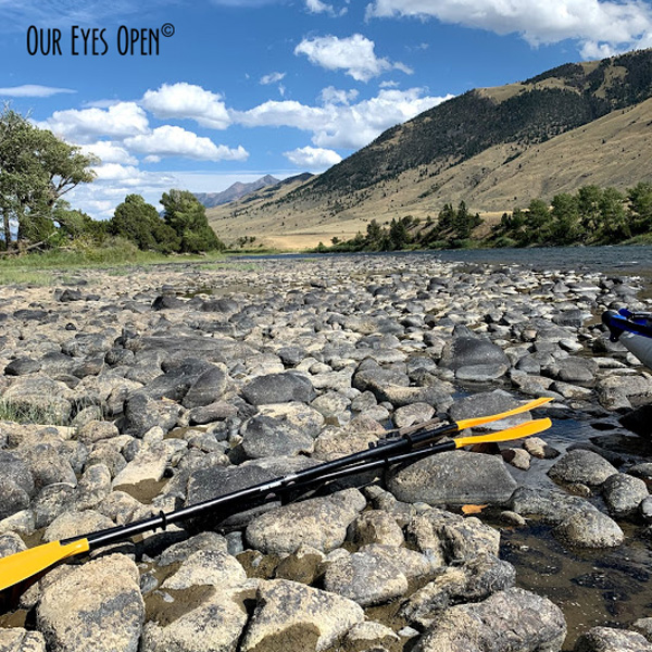 Kayaking paddles in the foreground with the mountains in the background near Emigrant, Montana along the Yellowstone River.