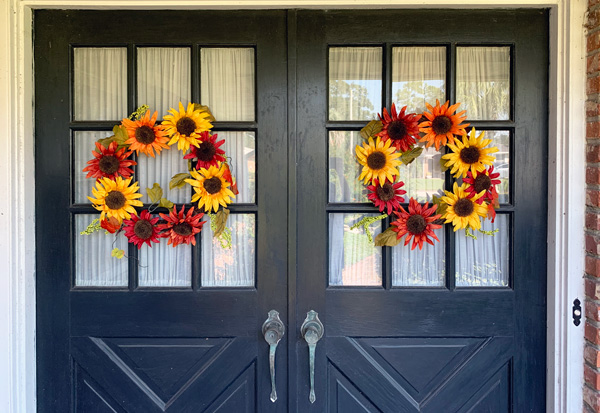 Fall color wreath hanging on my front doors.