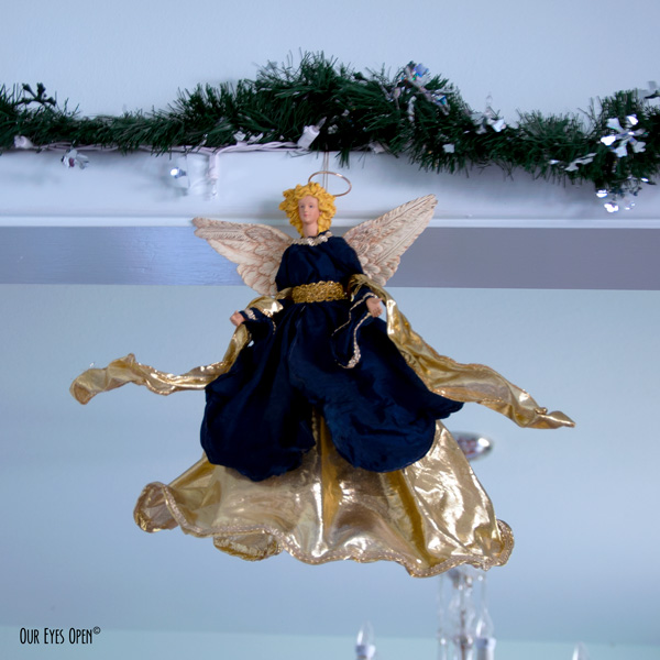 Our angel garnered in navy blue and gold looks upon us every Christmas season.  She is over 30 years old.