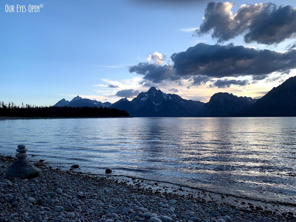 Clouds move past the mountain range at Colter Bay in Grand Teton National Park at sunset.
