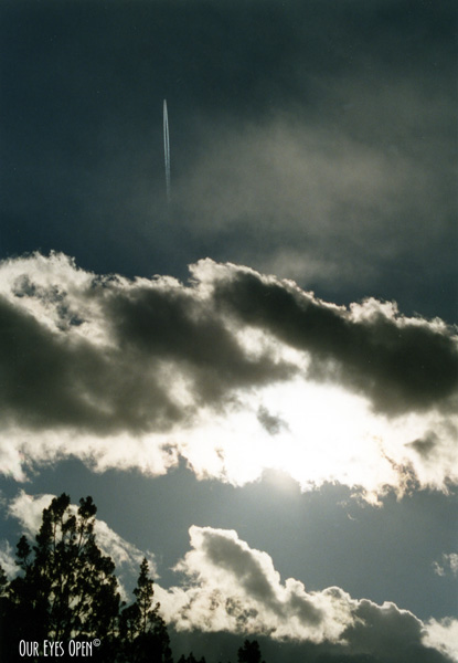 Jet soars upward above the clouds.