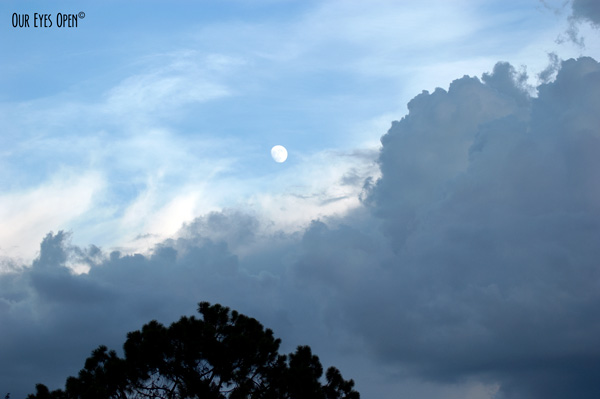 Moon rising above storm clouds moving in.