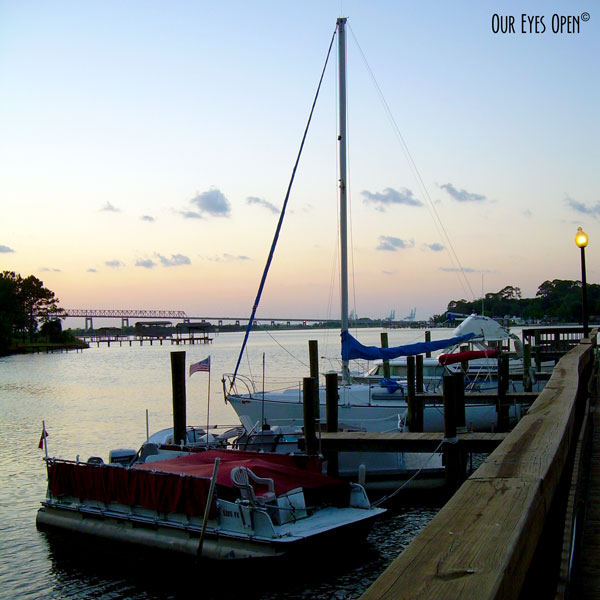 Boats docked overlooking the St. Johns River in Jacksonville, Florida just as the sun is going down.