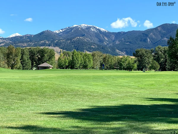 Bridger Creek Golf Course in Bozeman, Montana. This is a public golf course with the mountains standing stoic behind the tree lined fairways and greens.
